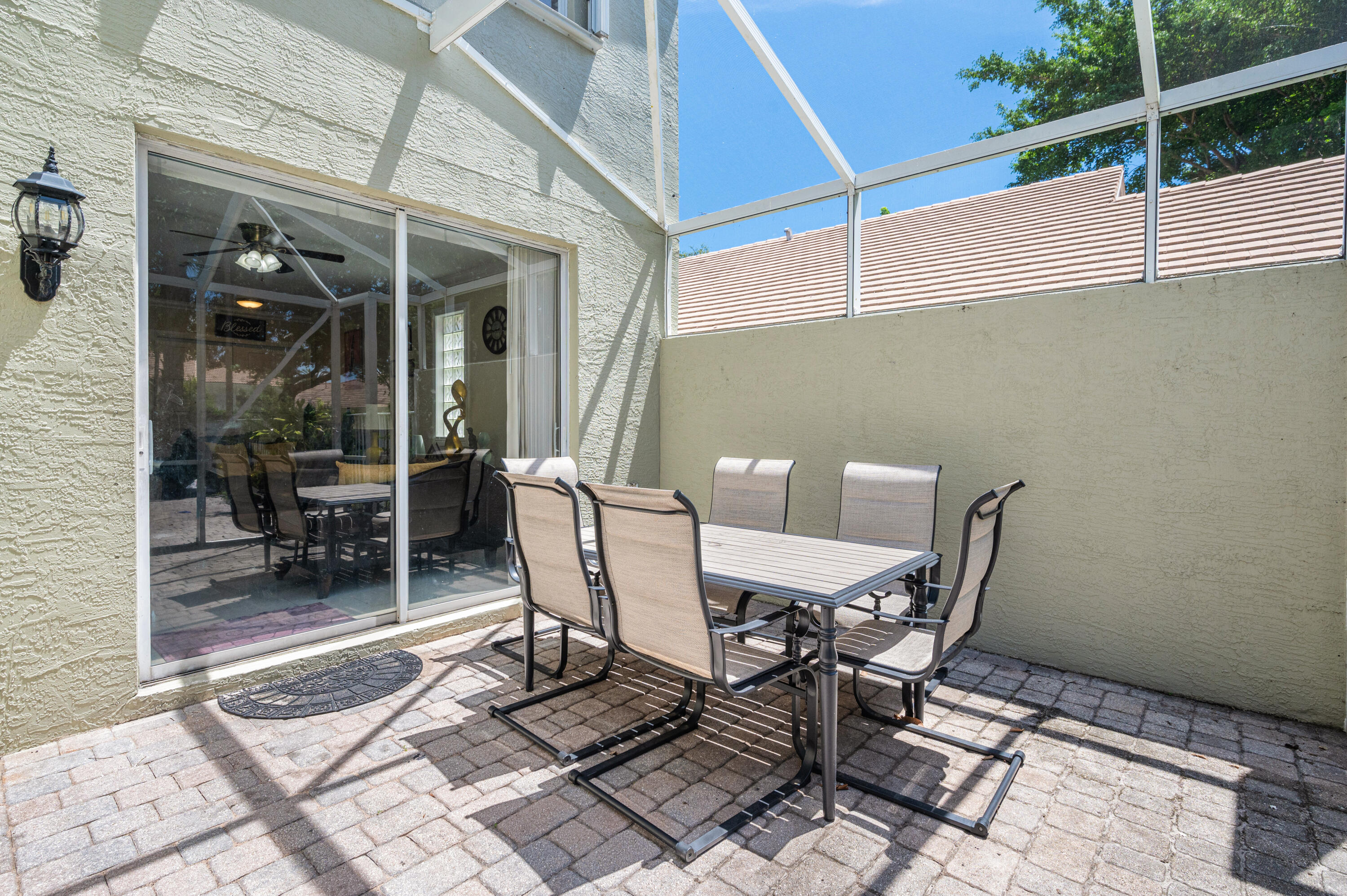 311 Berenger Walk Royal Palm Beach, FL 33414 - Photo 28 of 34 a patio with table and chairs and potted plants