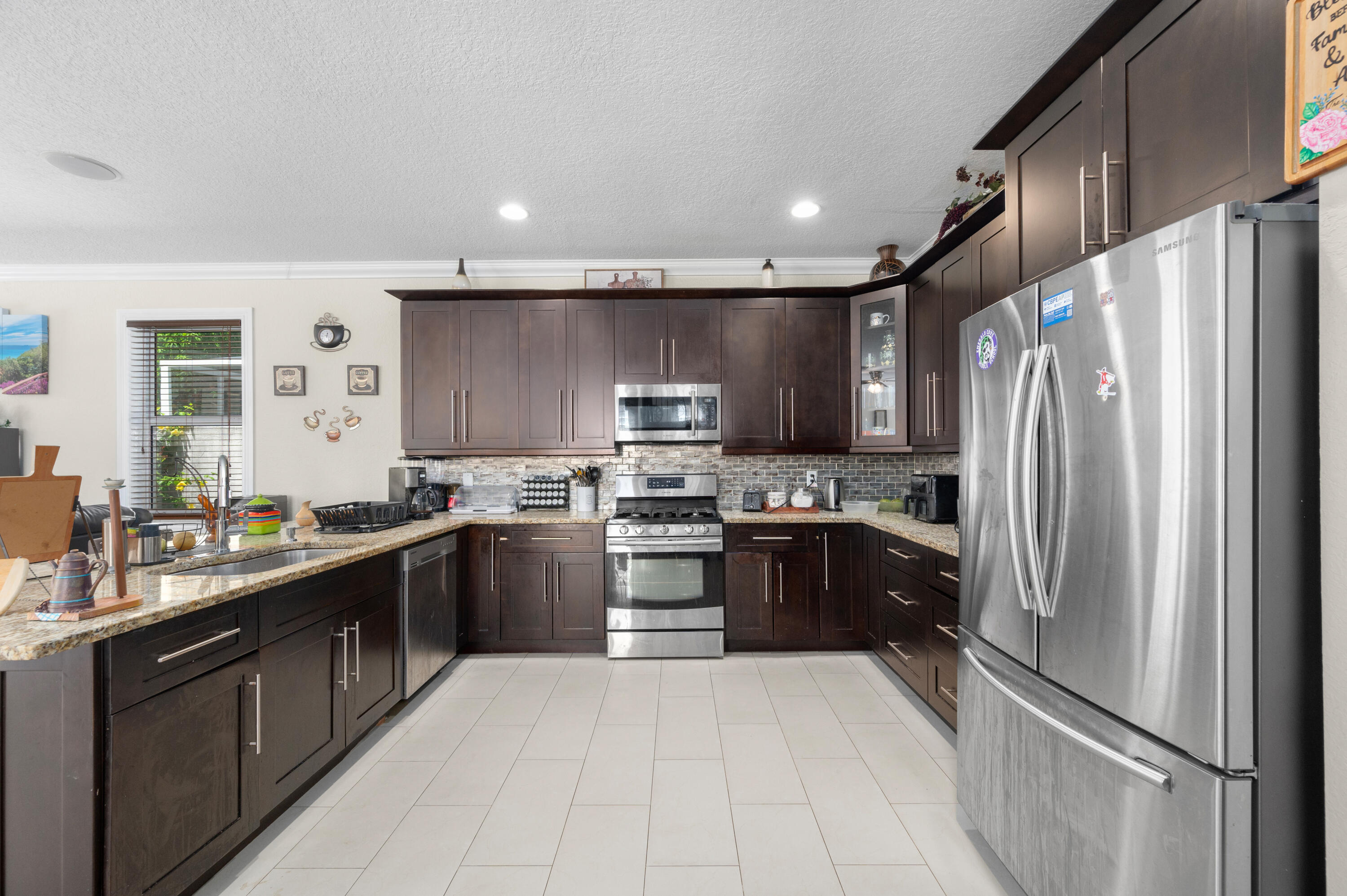 311 Berenger Walk Royal Palm Beach, FL 33414 - Photo 8 of 34 a large kitchen with stainless steel appliances granite countertop a refrigerator and a stove