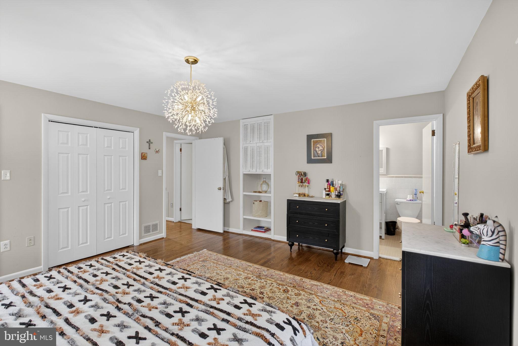 2849 Hideaway Road Fairfax, VA 22031 - Photo 19 of 45 a bedroom with a bed and a chandelier