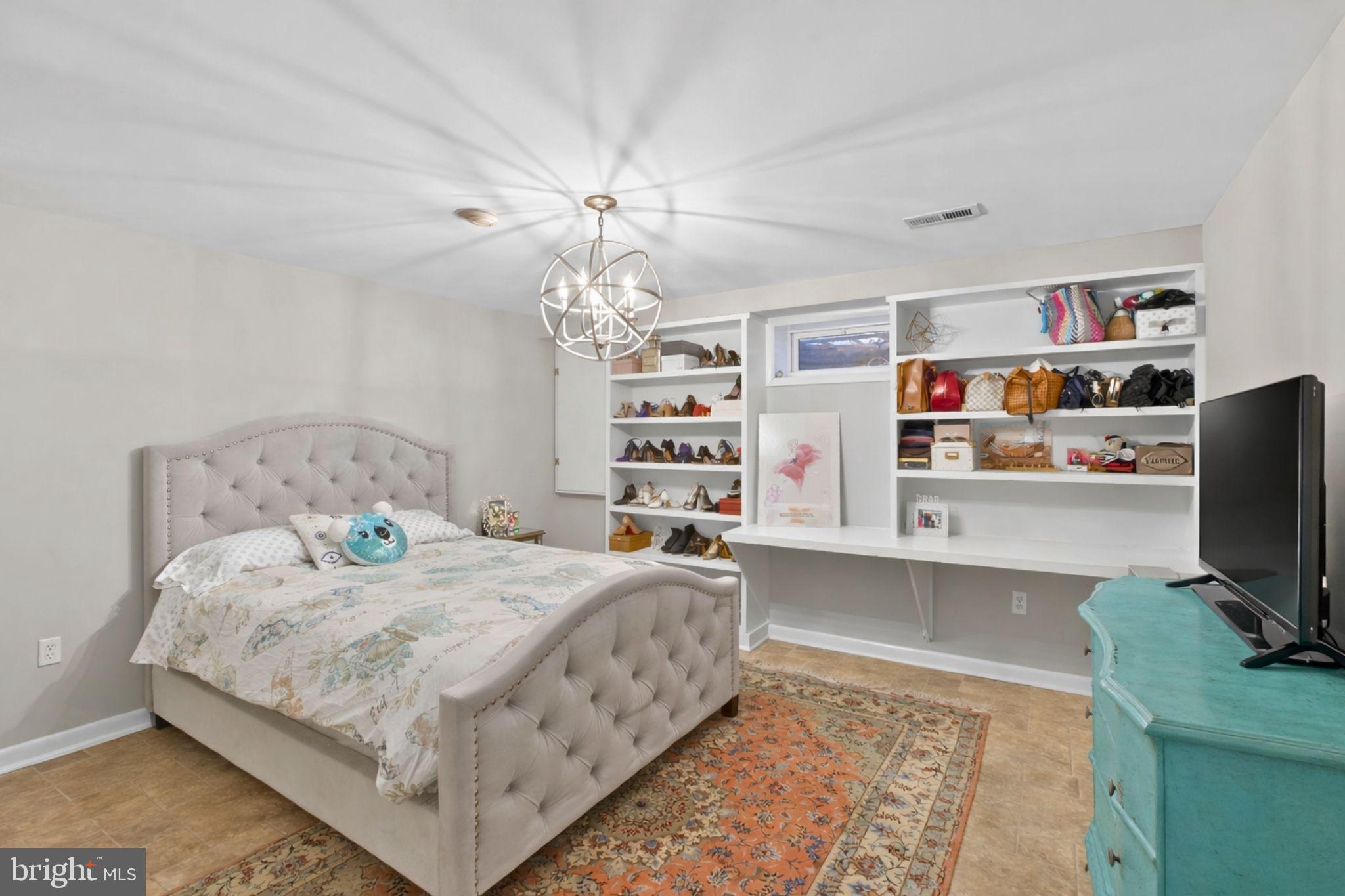2849 Hideaway Road Fairfax, VA 22031 - Photo 27 of 45 a bedroom with a bed bookshelf and a computer on a desk