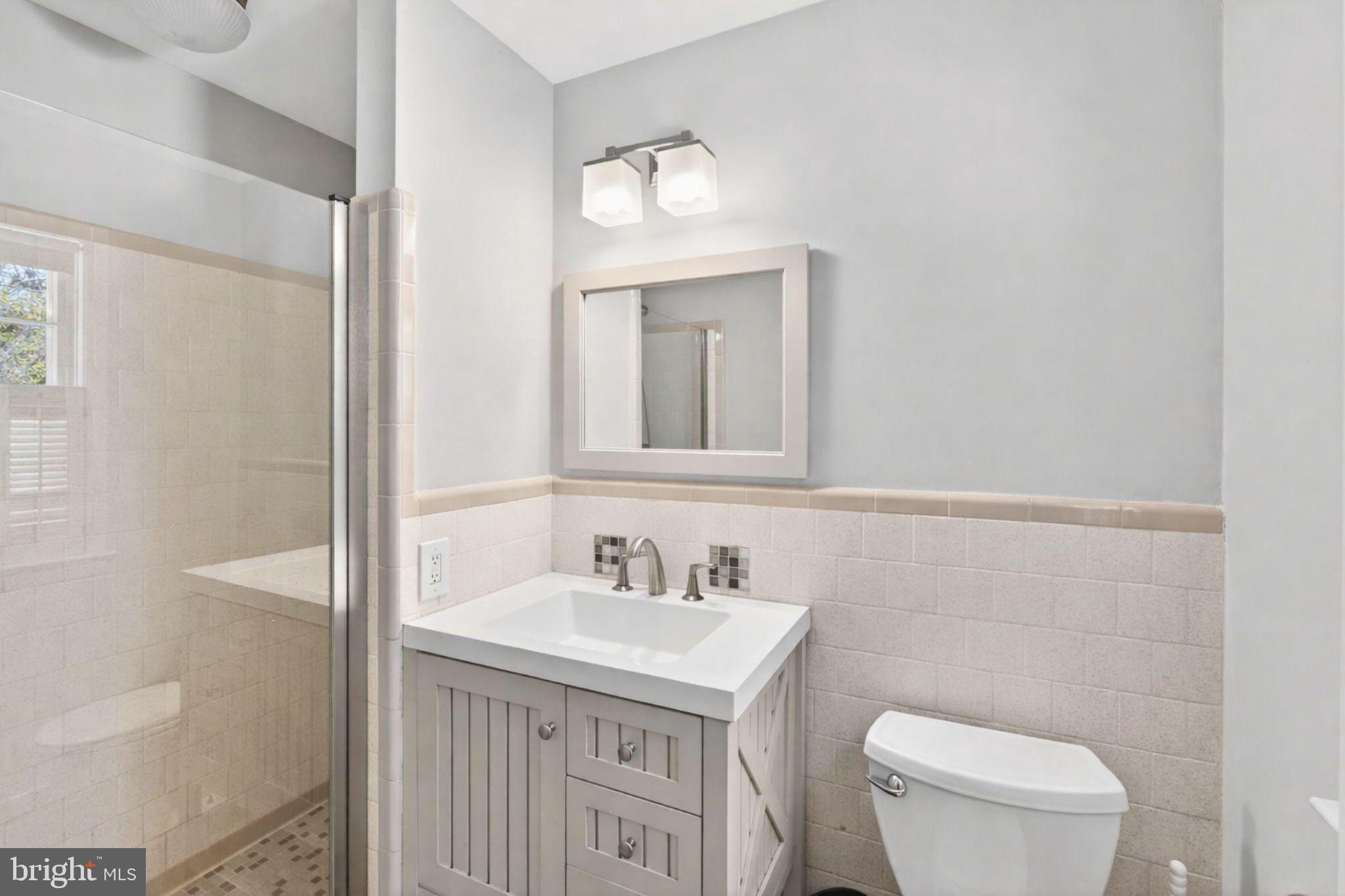 2849 Hideaway Road Fairfax, VA 22031 - Photo 28 of 45 a bathroom with a toilet a sink a mirror and vanity