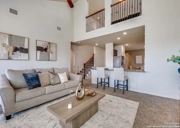 a living room with furniture and a rug