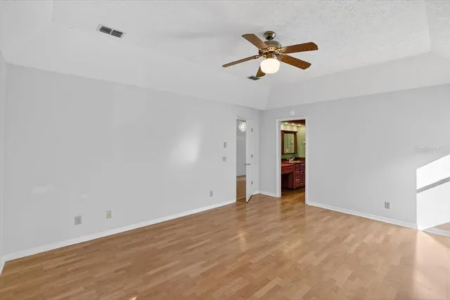 a kitchen with stainless steel appliances granite countertop a sink dishwasher a refrigerator with wooden floor and cabinets