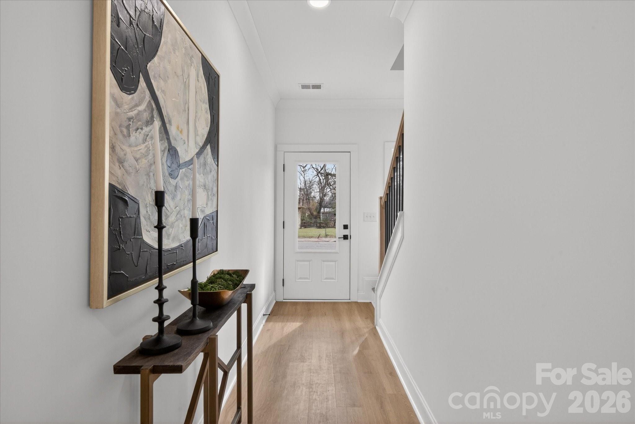 216 Lander Street Charlotte, NC 28208 - Photo 15 of 33 a view of a hallway with paintings on the wall