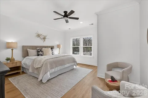 a bedroom with a large bed and a window