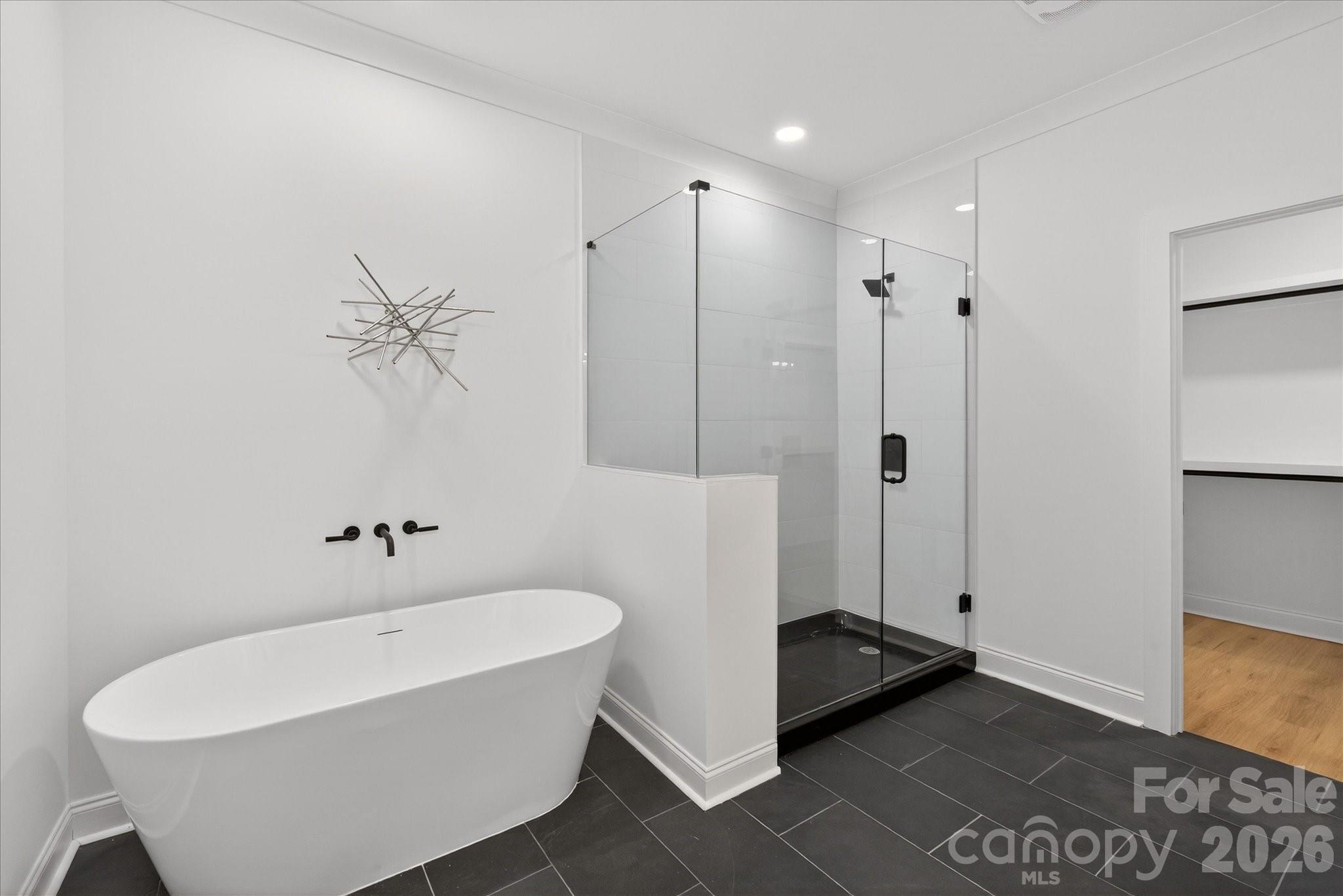 216 Lander Street Charlotte, NC 28208 - Photo 22 of 33 a bathroom with a bathtub and a shower