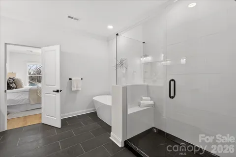 a bathroom with a sink a toilet a window and mirror