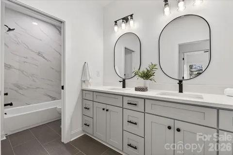 a bathroom with a double vanity sink and a mirror