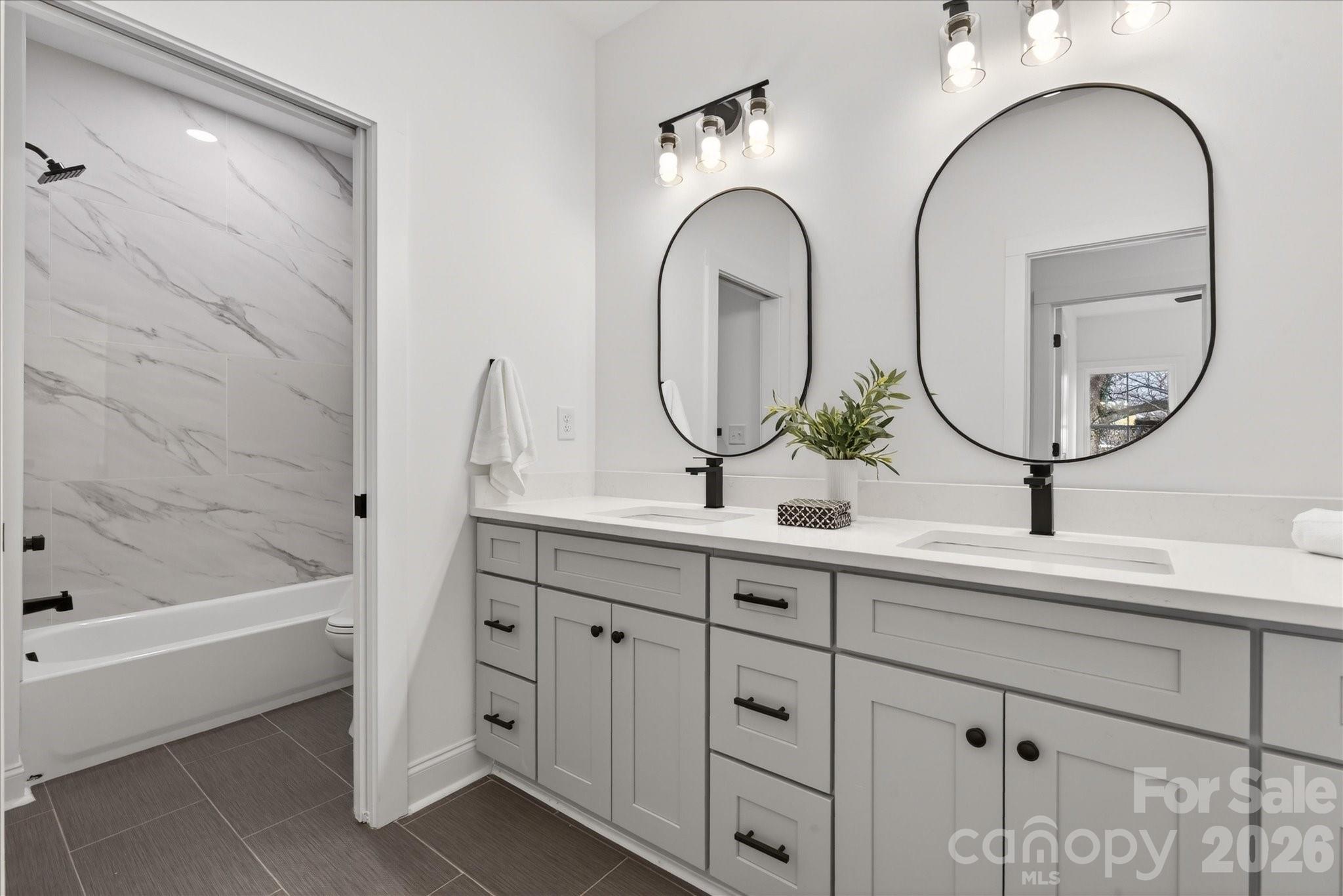 216 Lander Street Charlotte, NC 28208 - Photo 25 of 33 a bathroom with a double vanity sink and a mirror