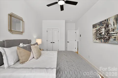 a bedroom with a bed and painting on the wall