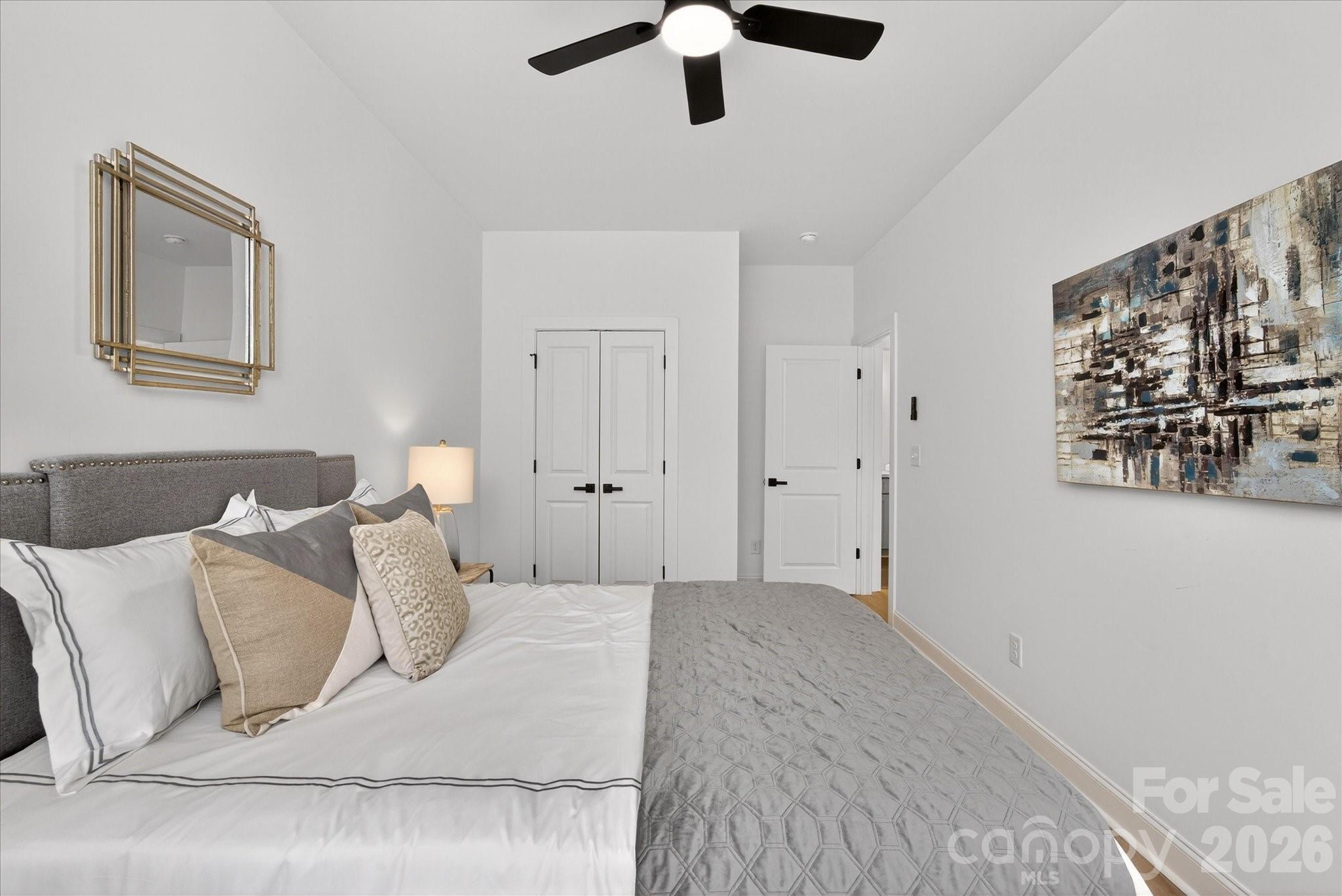 216 Lander Street Charlotte, NC 28208 - Photo 28 of 33 a bedroom with a bed and painting on the wall