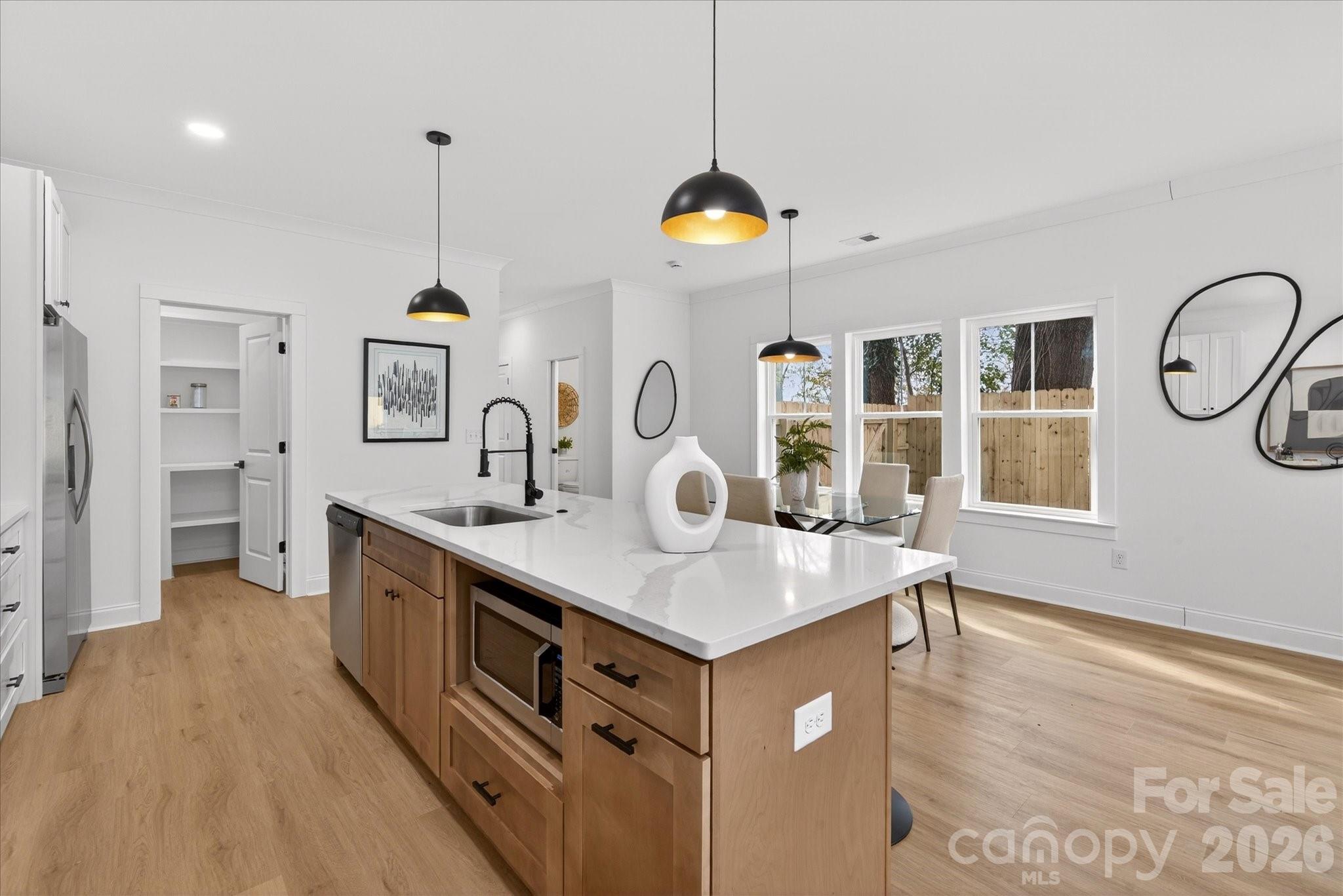216 Lander Street Charlotte, NC 28208 - Photo 4 of 33 a kitchen with stainless steel appliances granite countertop a sink a stove and a wooden floors