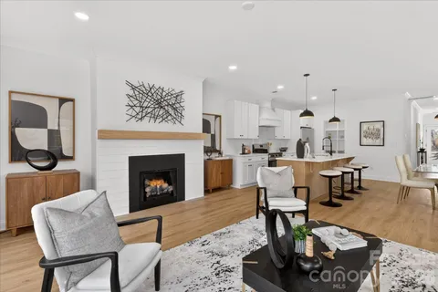 a living room with furniture a fireplace and a table