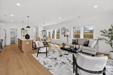 a living room with furniture and kitchen view