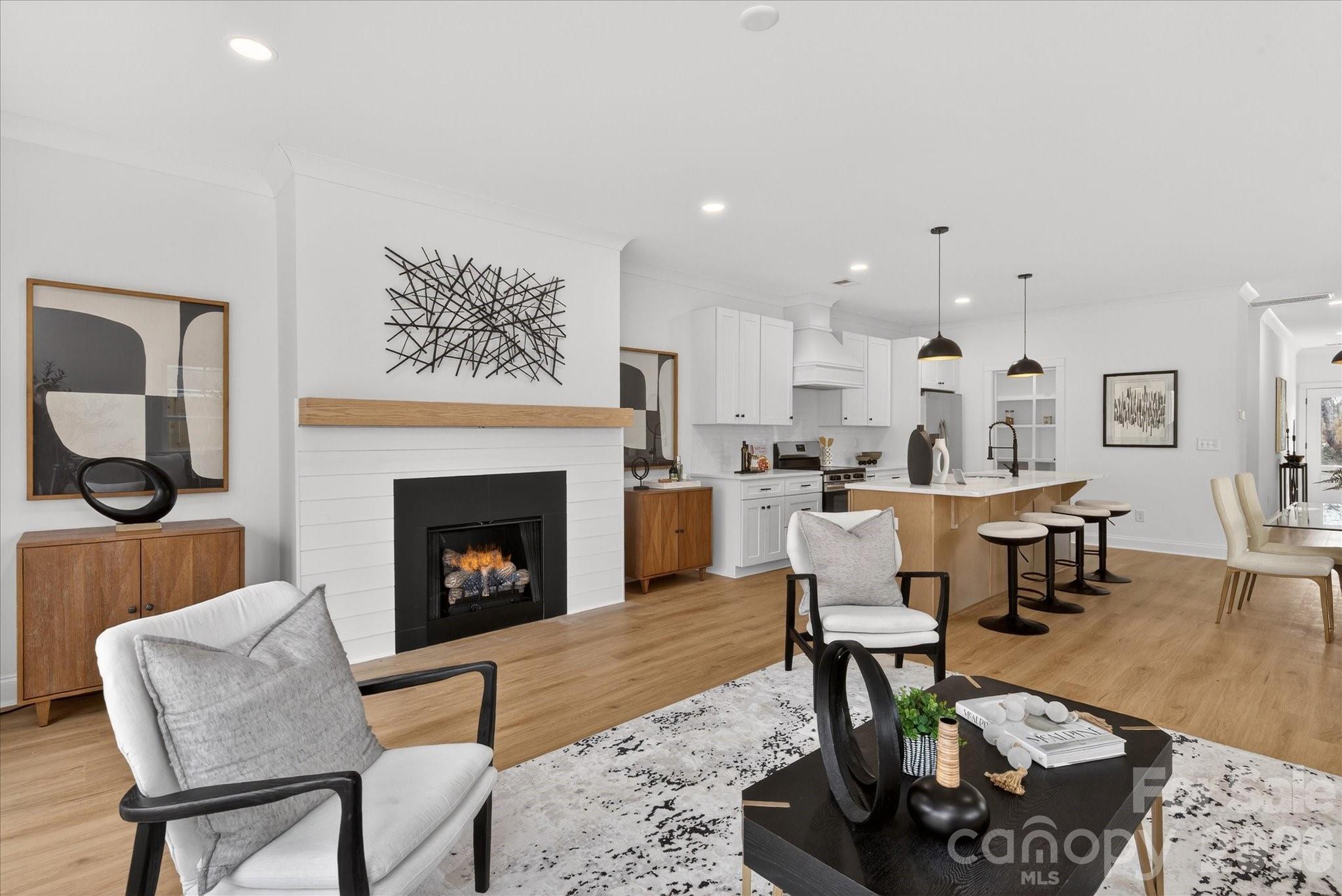 216 Lander Street Charlotte, NC 28208 - Photo 10 of 33 a living room with furniture a fireplace and a table