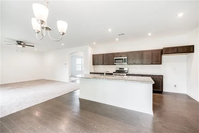 a view of kitchen with sink microwave and stove