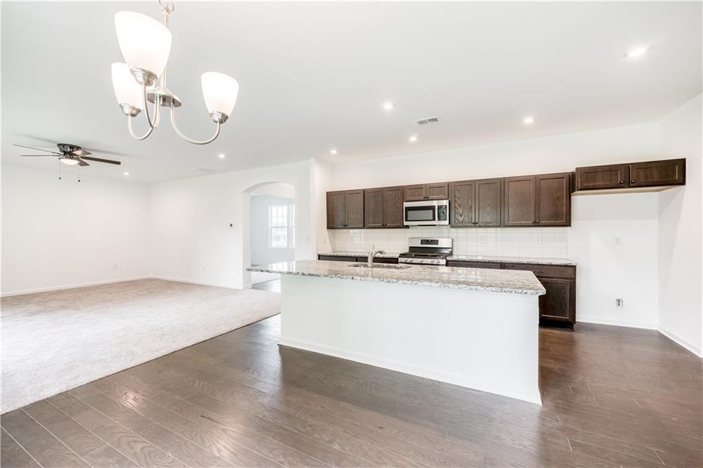 1377 R Liberty Park Drive Braselton, GA 30517 - Photo 12 of 38 a view of kitchen with sink microwave and stove