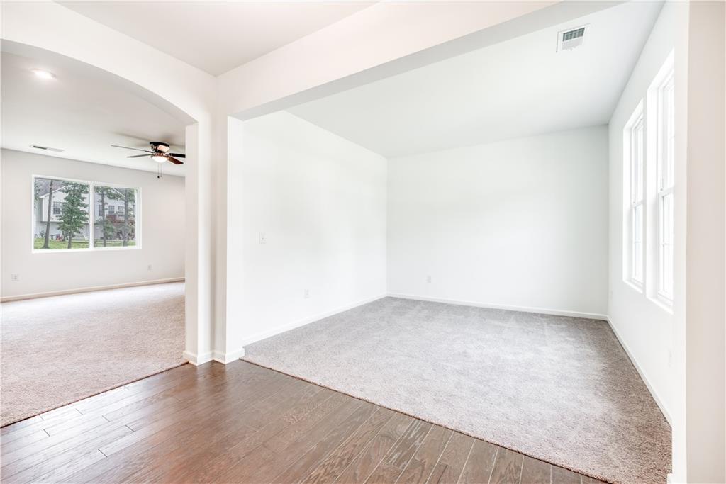 1377 R Liberty Park Drive Braselton, GA 30517 - Photo 15 of 38 an empty room with wooden floor and windows