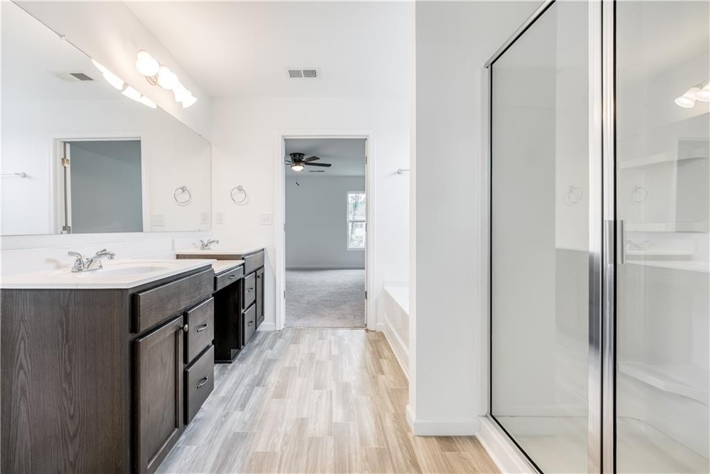 1377 R Liberty Park Drive Braselton, GA 30517 - Photo 23 of 38 a spacious bathroom with a double vanity sink and mirror