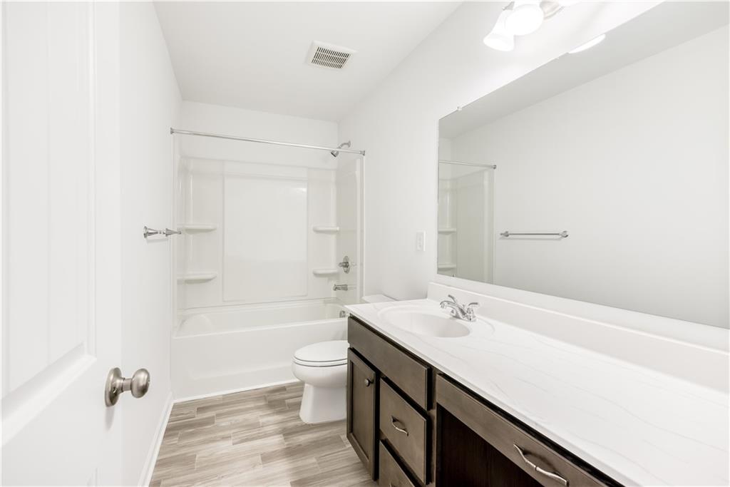 1377 R Liberty Park Drive Braselton, GA 30517 - Photo 24 of 38 a bathroom with a sink a toilet a shower and a mirror