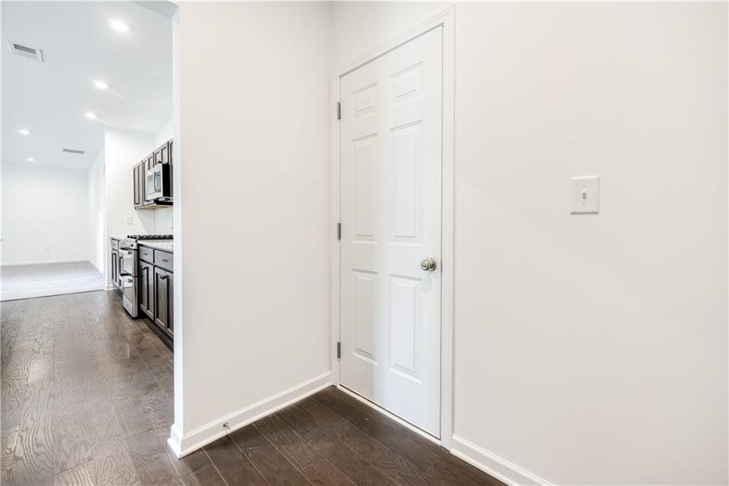 1377 R Liberty Park Drive Braselton, GA 30517 - Photo 25 of 38 an empty room with wooden floor