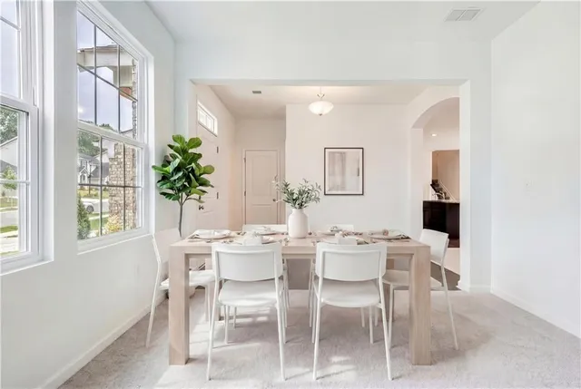 a view of a dining room with furniture and window