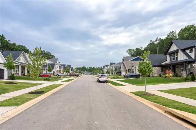 a view of a street with a cars parked in front of it