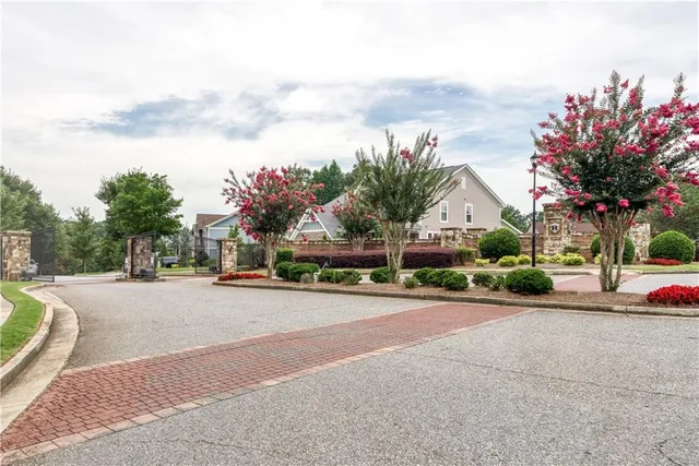 a view of a hallway with wooden floor and a living room