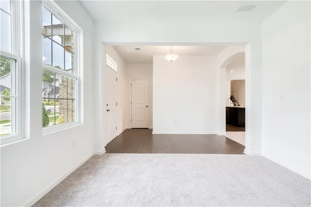 an empty room with windows and closet