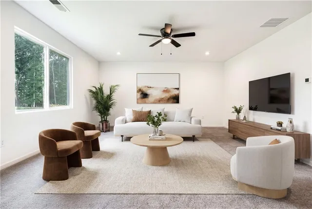 a living room with furniture a flat screen tv and a large window
