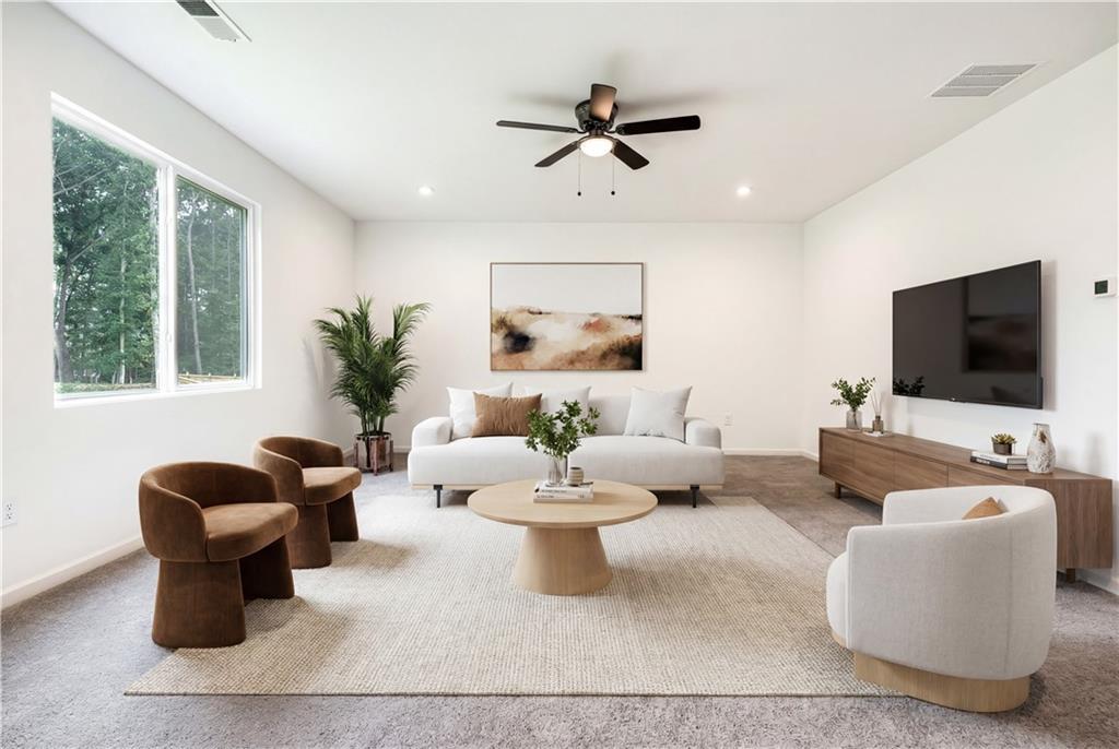 1377 R Liberty Park Drive Braselton, GA 30517 - Photo 5 of 38 a living room with furniture a flat screen tv and a large window