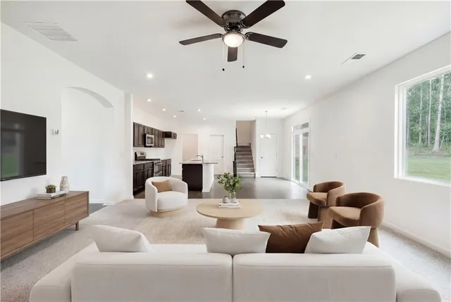 a living room with furniture and a flat screen tv
