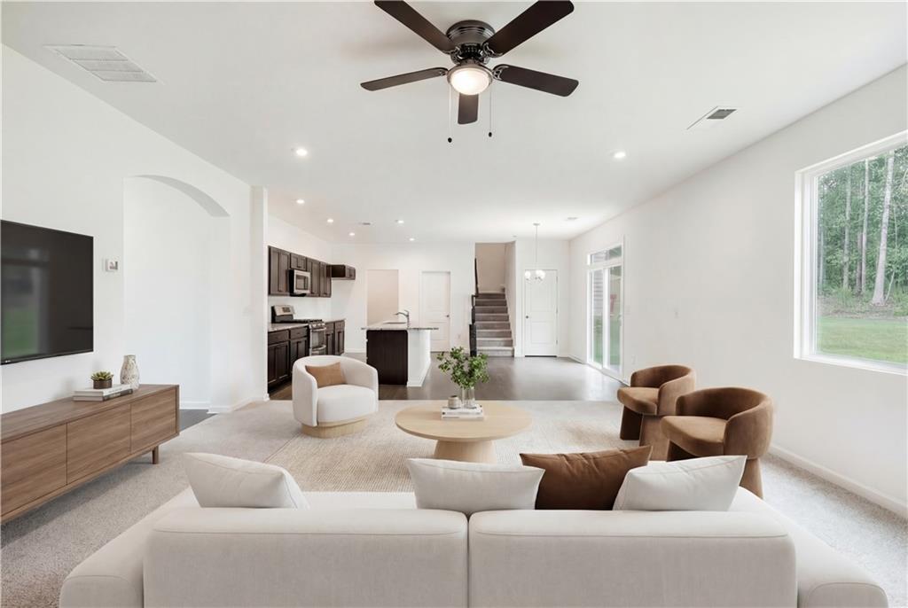 1377 R Liberty Park Drive Braselton, GA 30517 - Photo 8 of 38 a living room with furniture and a flat screen tv