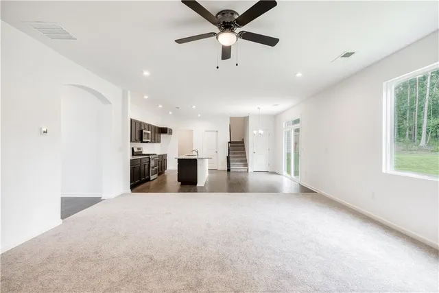 a view of a kitchen with refrigerator and windows