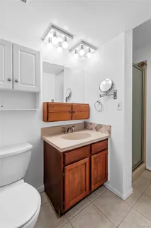 a bathroom with a toilet sink and mirror
