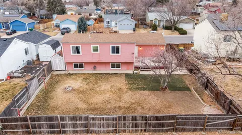 an aerial view of residential houses with yard