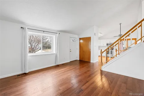 a view of an entryway with wooden floor