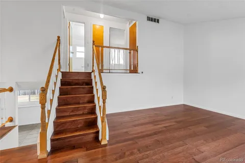 a view of entryway with wooden floor and front door