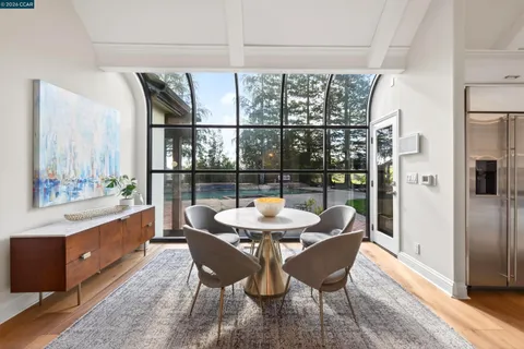 a living room with furniture a fireplace a flat screen tv and couches