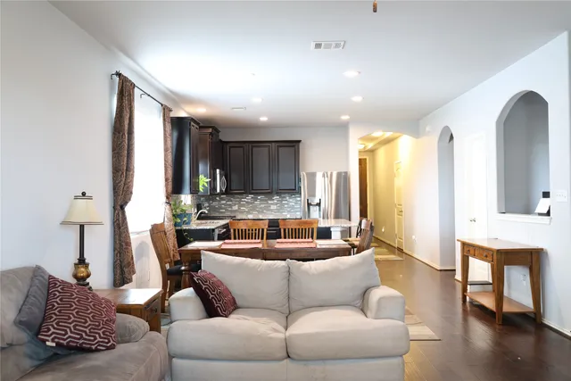 a living room with furniture and wooden floor