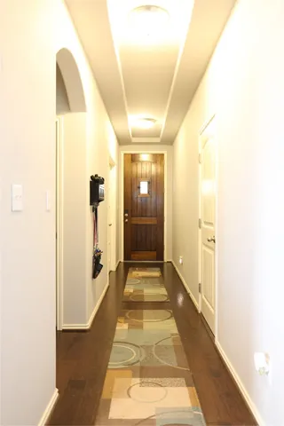 a view of a room with shelves and wooden floor