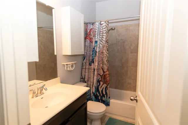 a view of a patio with table and chairs with wooden floor and fence