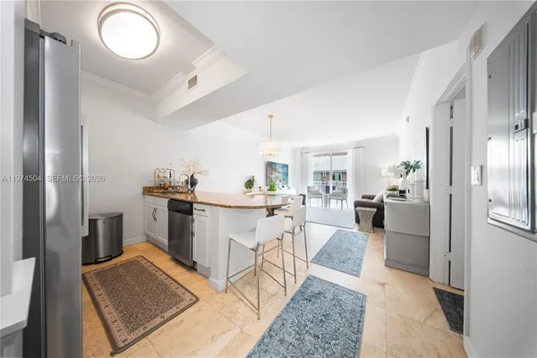 a open kitchen with white cabinets and stainless steel appliances