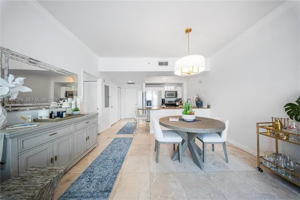 a large kitchen with a table and chairs