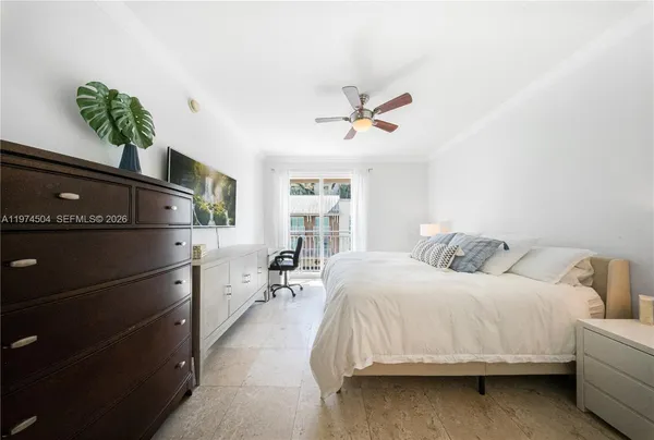 a bedroom with a bed dresser and a window