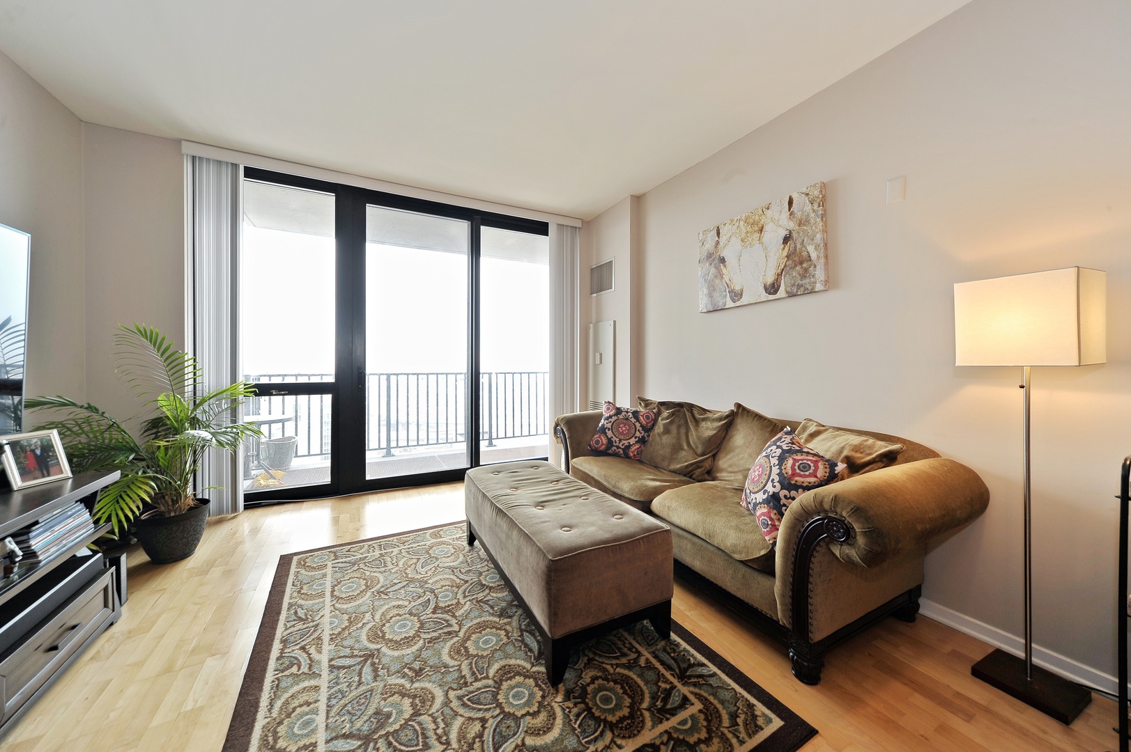 210 South Desplaines Street, Unit 2104 Chicago, IL 60661 - Photo 2 of 9 a living room with furniture and a large window