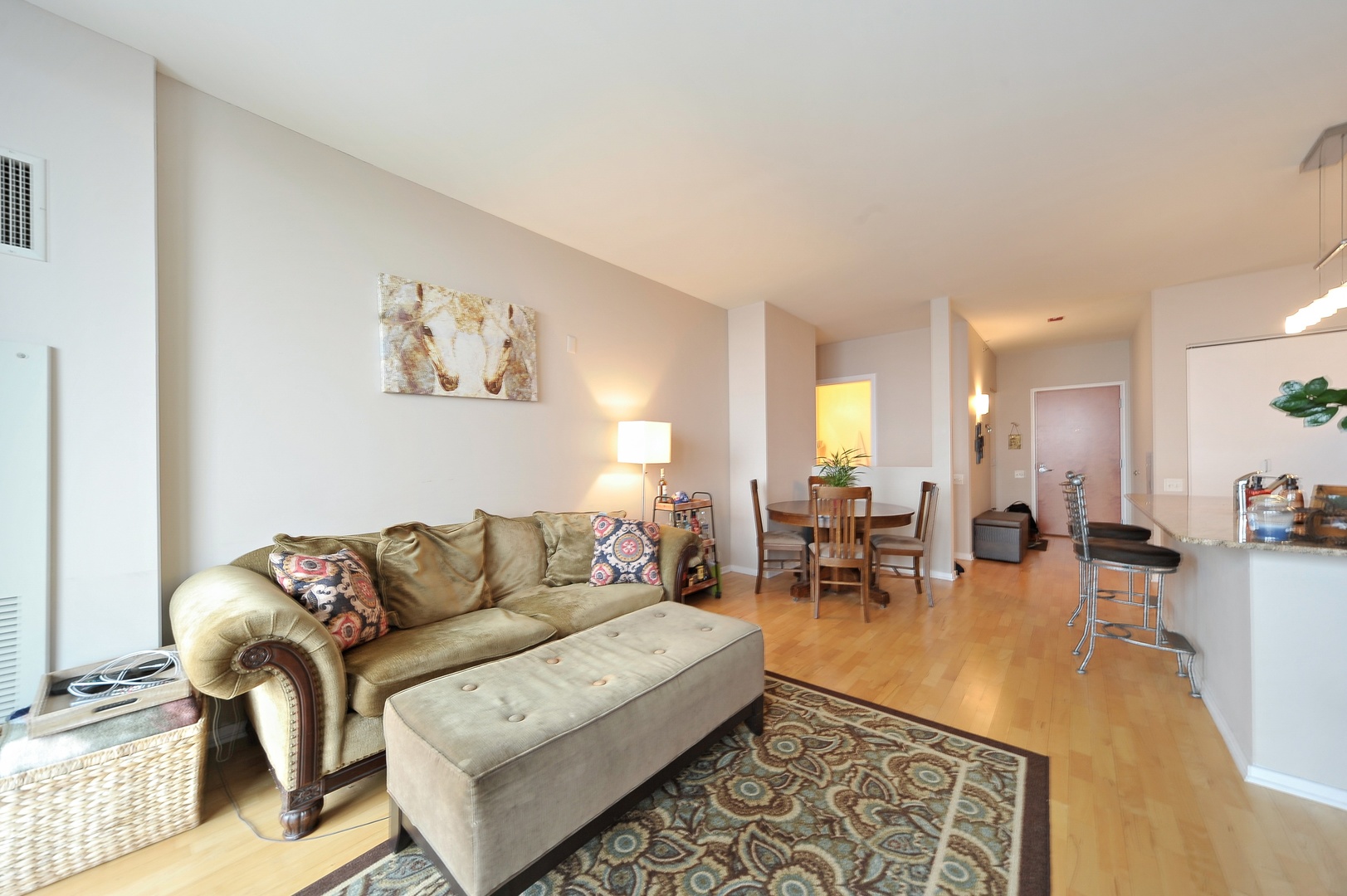 210 South Desplaines Street, Unit 2104 Chicago, IL 60661 - Photo 3 of 9 a living room with furniture and wooden floor