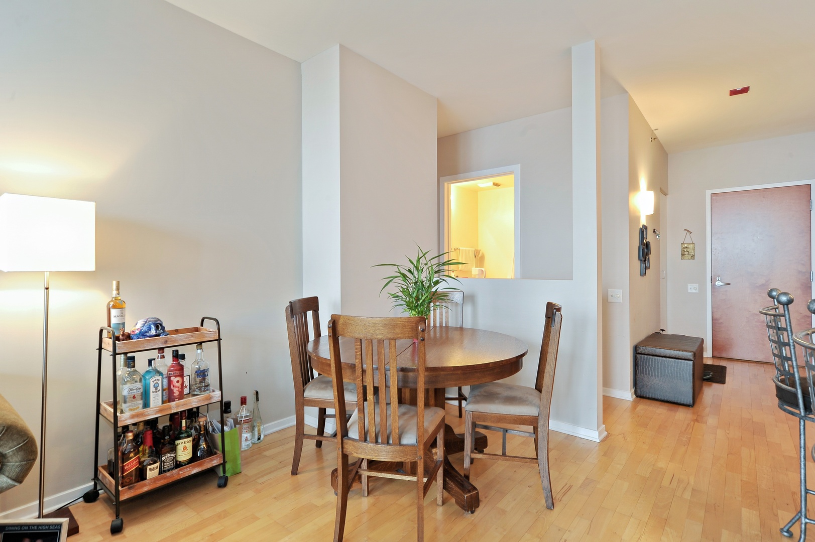 210 South Desplaines Street, Unit 2104 Chicago, IL 60661 - Photo 6 of 9 a dining room with furniture and a book shelf
