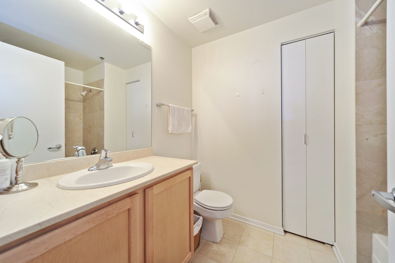 210 South Desplaines Street, Unit 2104 Chicago, IL 60661 - Photo 8 of 9 a bathroom with a sink toilet and shower