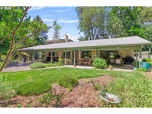 a front view of a house with a yard table and chairs